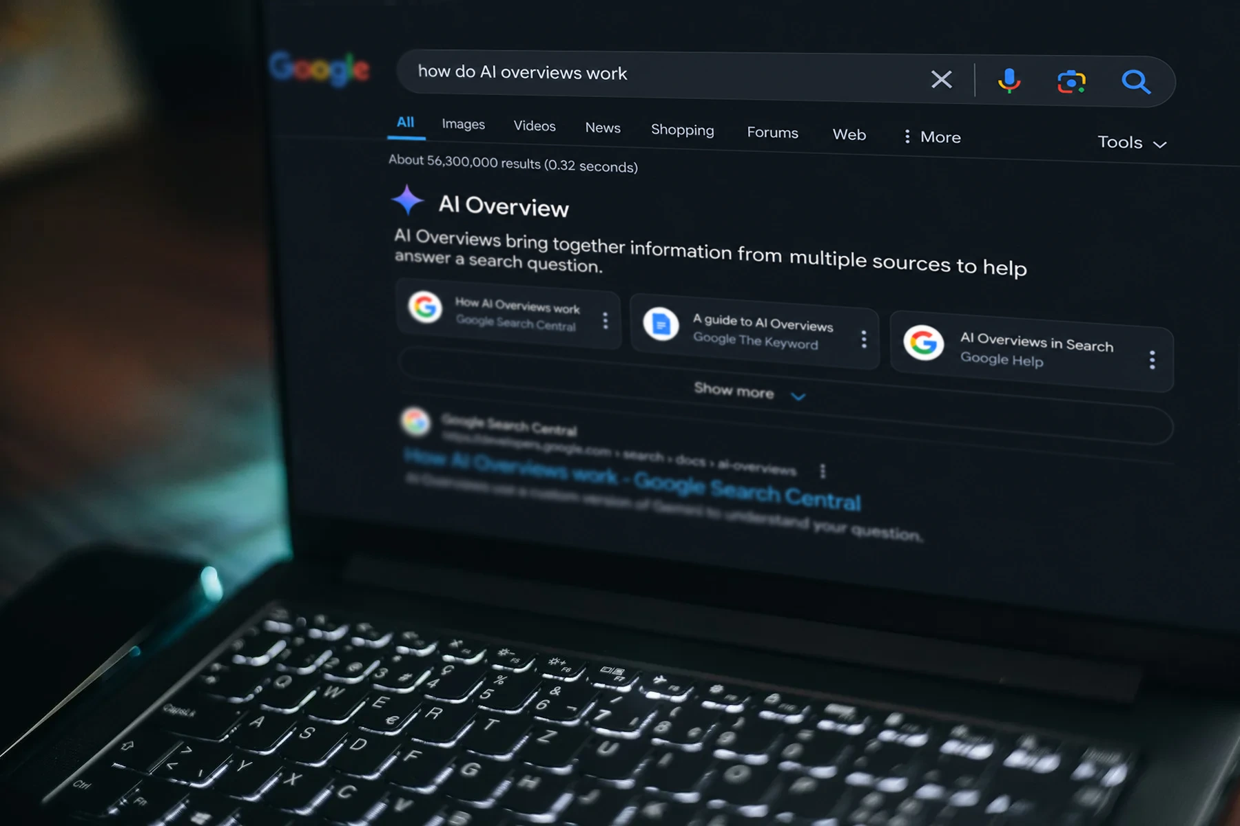 AI-edited illustration of Google Search results with an AI Overview on a laptop in a dark workspace.